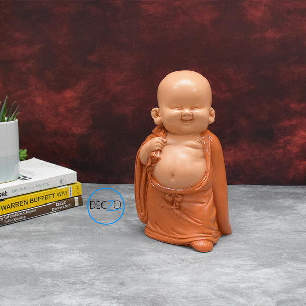 Baby Monk Holding Money Bag Showpiece :  23 CM, Orange