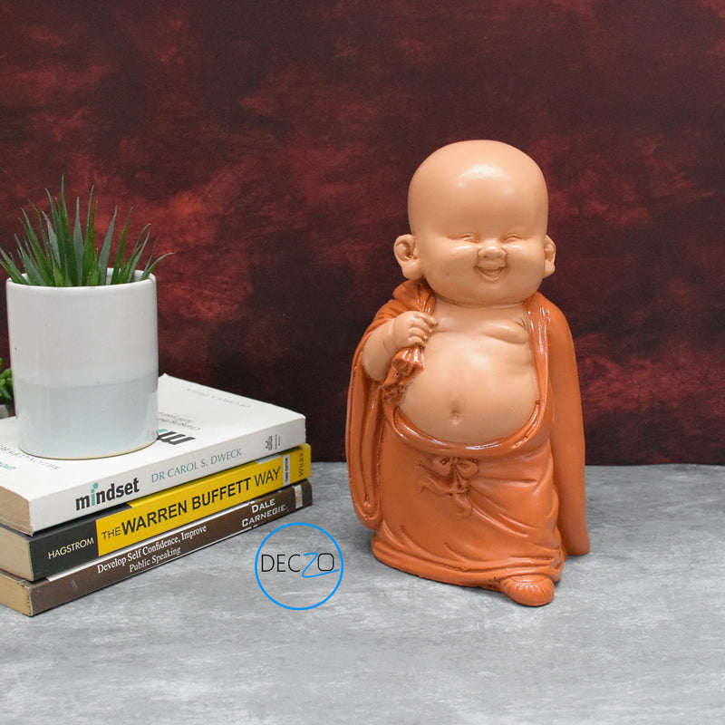 Baby Monk Holding Money Bag Showpiece :  23 CM, Orange
